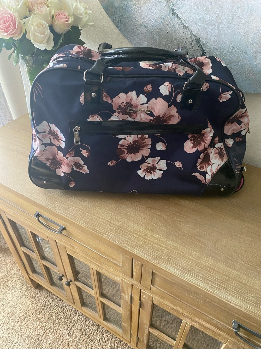 bebe Giselle Rolling Duffel Bag.